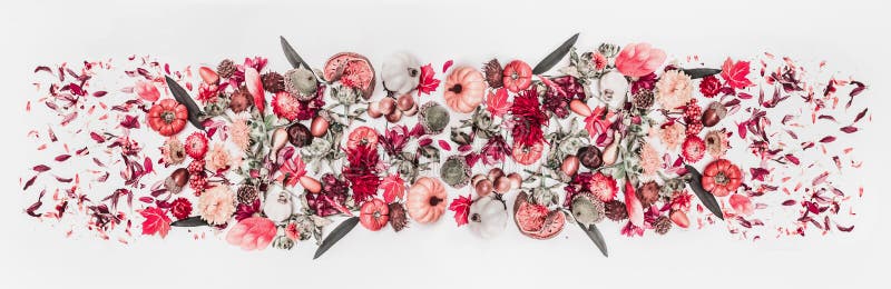 Creative autumn arrangement composition with fall leaves, flowers, little pumpkins, nuts and decoration on white desk background.