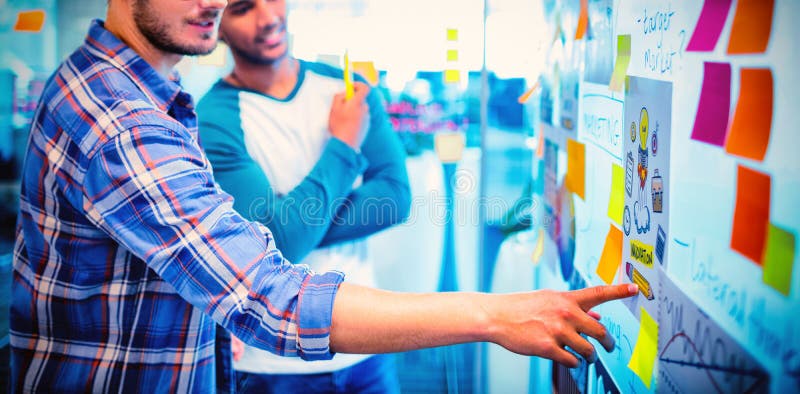 Creative business team reading the sticky notes and discussing royalty free stock photo Creative business team reading the sticky notes and discussing royalty free stock photo