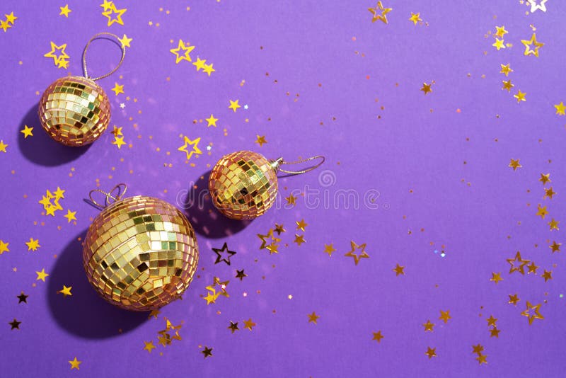 New year baubles. Shiny gold disco balls on neon background. Pop disco  style attributes, retro Stock Photo by jchizhe