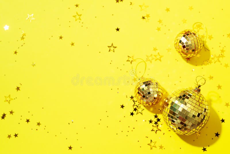 New year baubles. Shiny gold disco balls on neon background. Pop disco  style attributes, retro Stock Photo by jchizhe