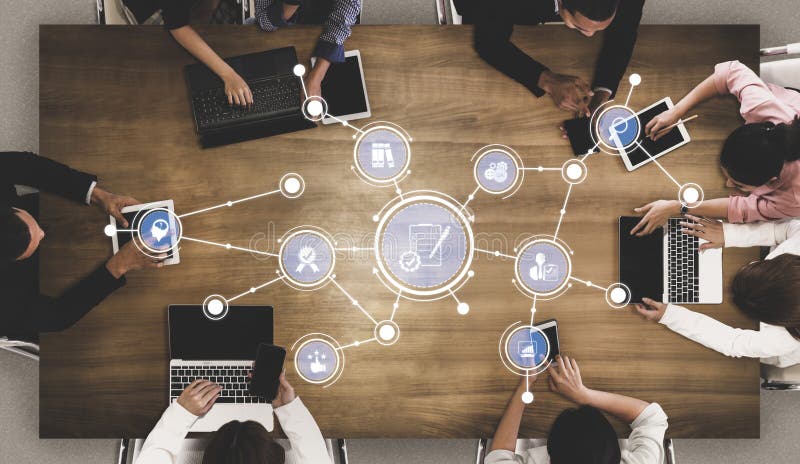 Creative Collaboration Concept with Diverse Group Working on Laptops Around a Wooden Table with Digital Icons stock image