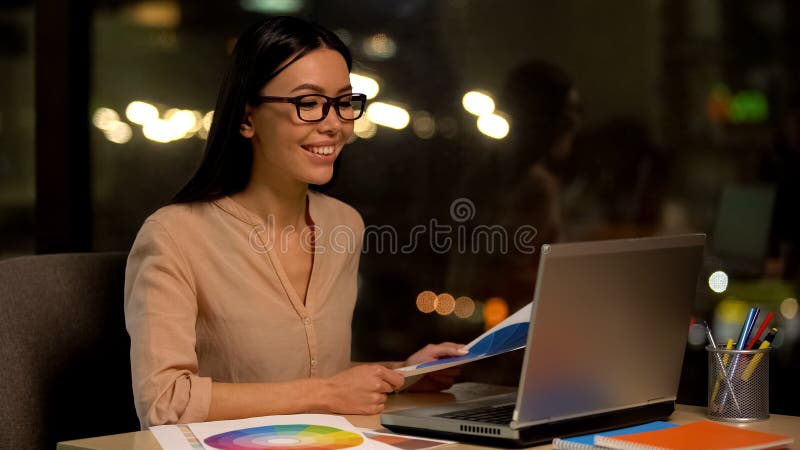 Creative designer reviewing color palette using laptop, enjoying favorite job stock photos Creative designer reviewing color palette using laptop, enjoying favorite job stock photos