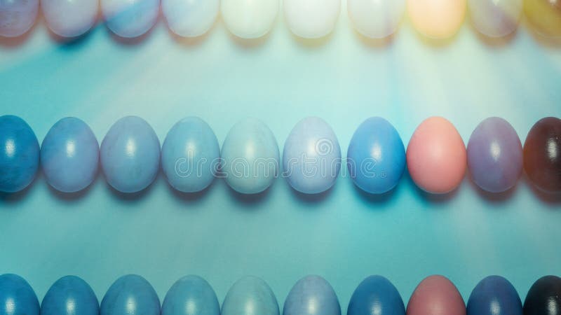 Creative Easter concept. Colored Easter eggs of a blue gradient in a row on a blue background. View from above royalty free stock photos