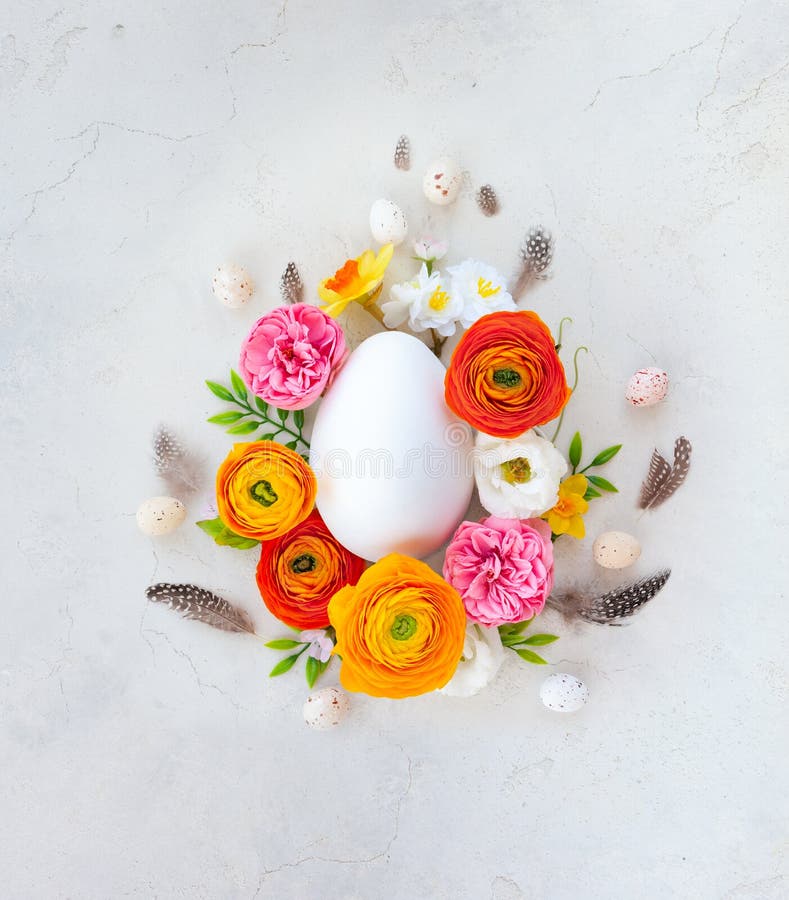 Creative Easter concept made of eggs feathers and spring flowers around on vintage background. Flat lay royalty free stock photos