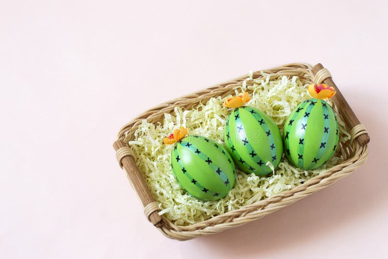 Creative Easter decor of cactus-shaped eggs in basket stock images