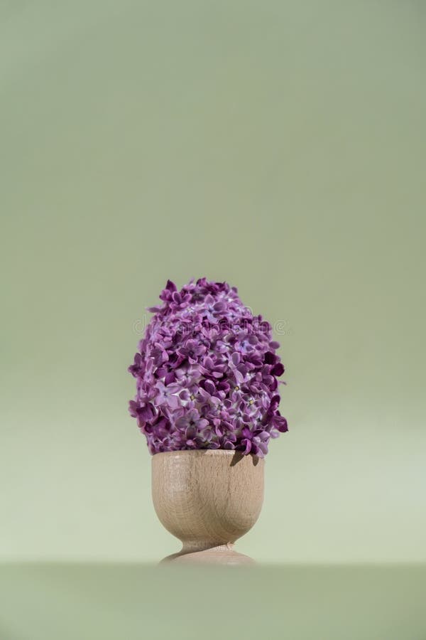 Creative Easter egg shape made of lilac spring petals flowers. Minimal holiday concept still life. Copy space greeting stock photo