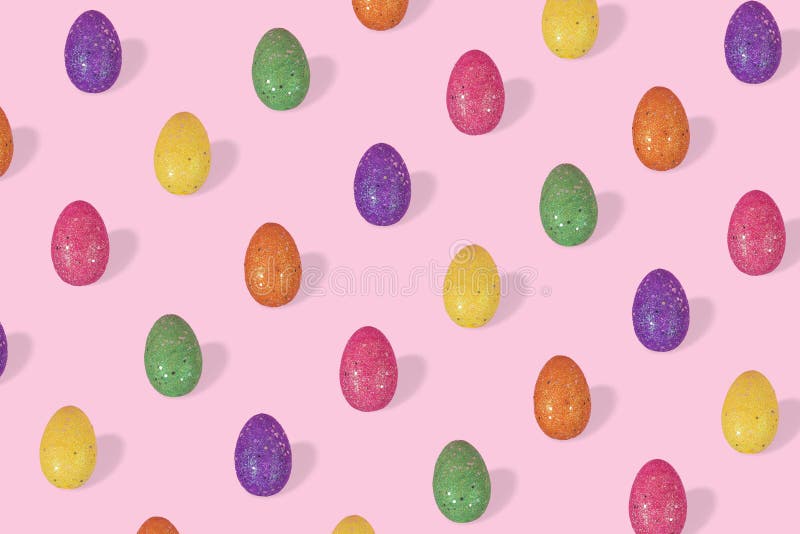 Creative Easter pattern made of colorful eggs arranged on bright blue background royalty free stock photography