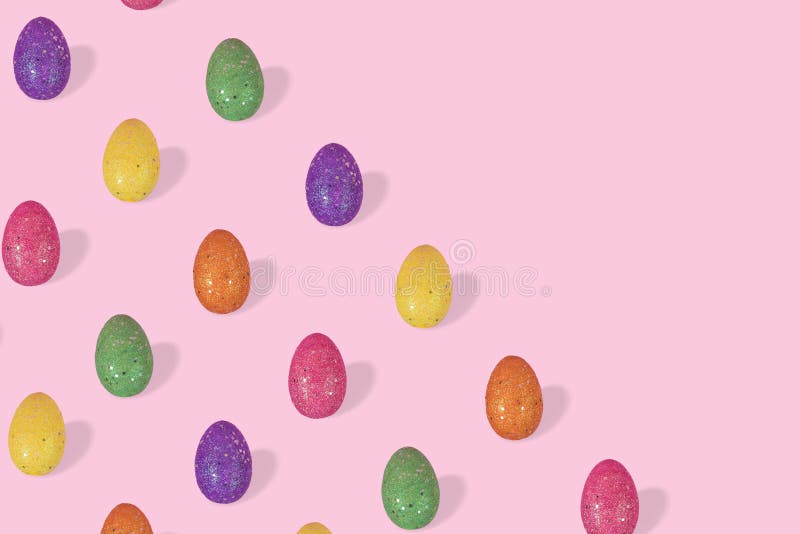 Creative Easter pattern made of colorful eggs arranged on pastel pink background with space for text royalty free stock photography