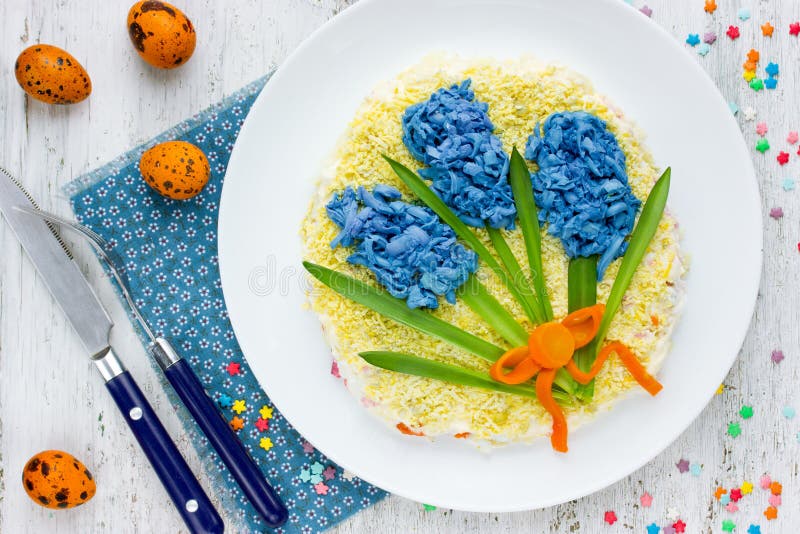 Creative Easter salad decorated with colored blue egg royalty free stock image