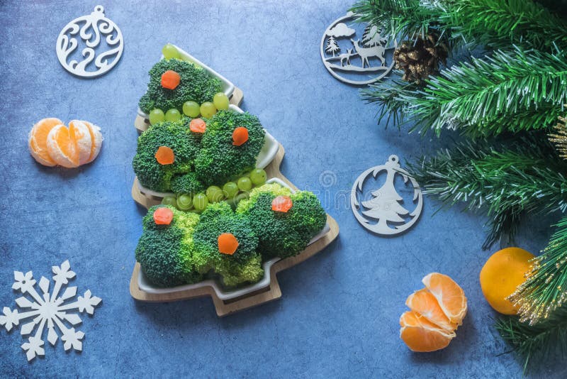 Creative edible Christmas tree made of fresh broccoli.Holiday ideas. New year food background top view . holiday, celebration, .