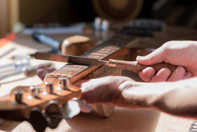 Luthier craftsman in home workshop stock photos