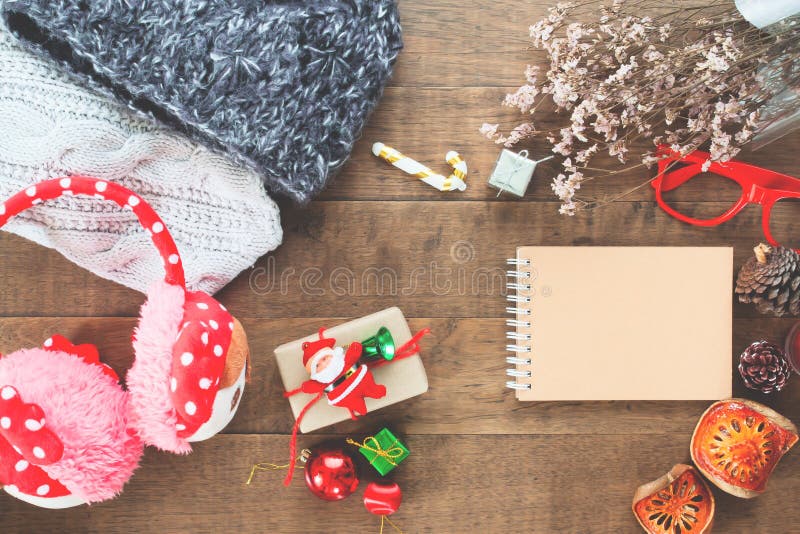 Creative flat lay of Christmas ornaments, winter accessories and craft notebook on wood background royalty free stock photos Creative flat lay of Christmas ornaments, winter accessories and craft notebook on wood background royalty free stock photos