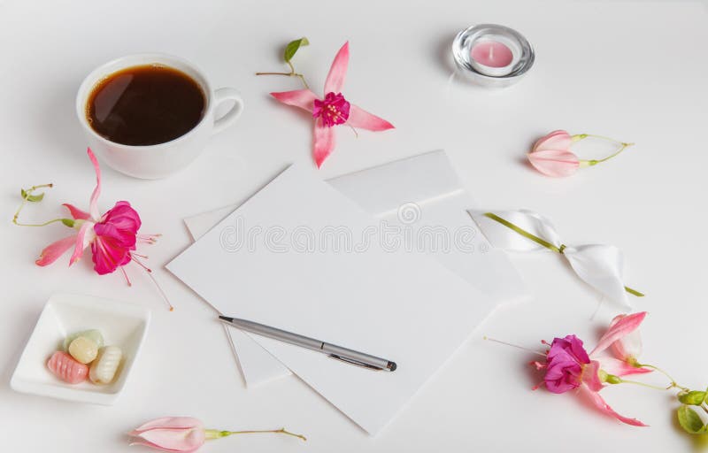 Creative flat lay photo of workspace desk with smartphone, coffee, pencil, flowers with copy space background. Flat lay