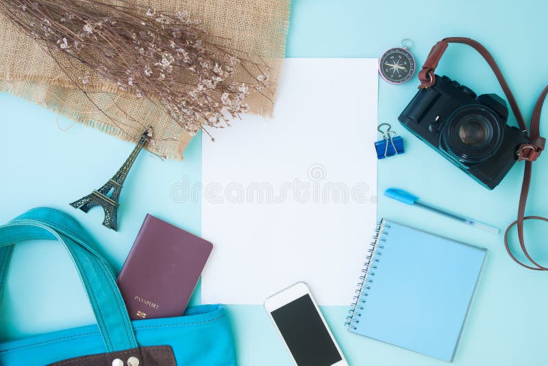 Creative flat lay travel items on blue pastel color background,