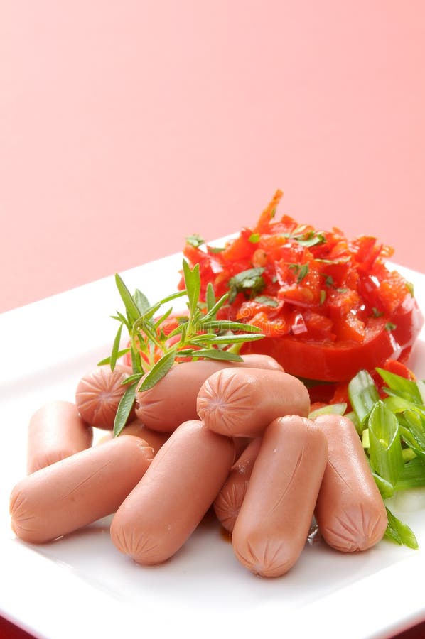 Chicken & Beef cocktail sausage with cherry tomato radish and lemon with green herb with toast bread on green red and bamboo backg. Creative food photography for royalty free stock photography Chicken & Beef cocktail sausage with cherry tomato radish and lemon with green herb with toast bread on green red and bamboo backg. Creative food photography for royalty free stock photography