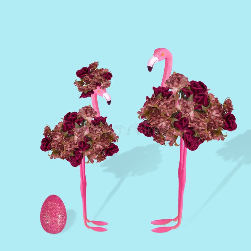 Creative idea with stylized couple of flamingo and Easter pink egg on a pastel blue background royalty free stock images