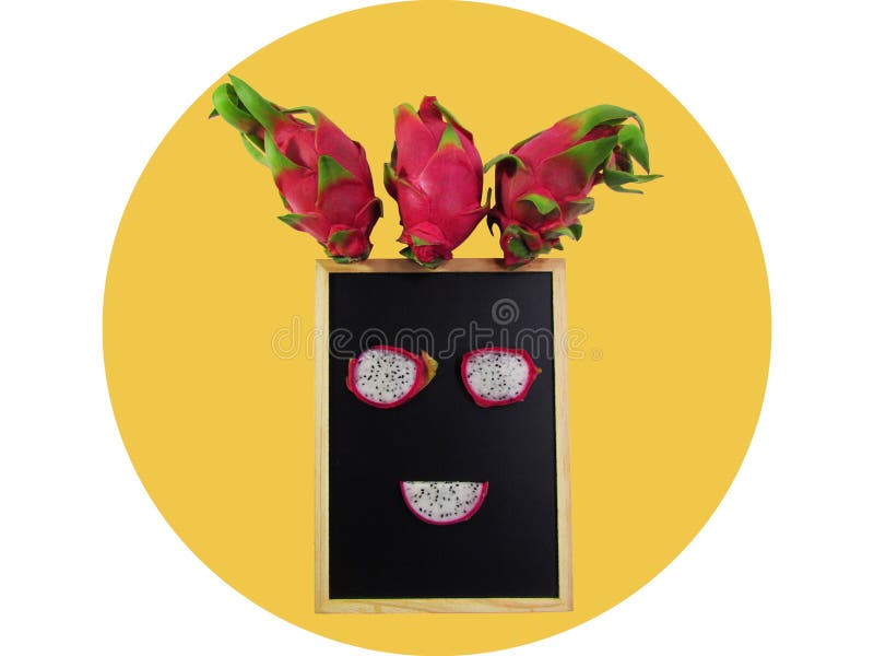 Creative layout made of dragon fruit on the chalkboard frame put a face isolated on yellow circle stock photo Creative layout made of dragon fruit on the chalkboard frame put a face isolated on yellow circle stock photo