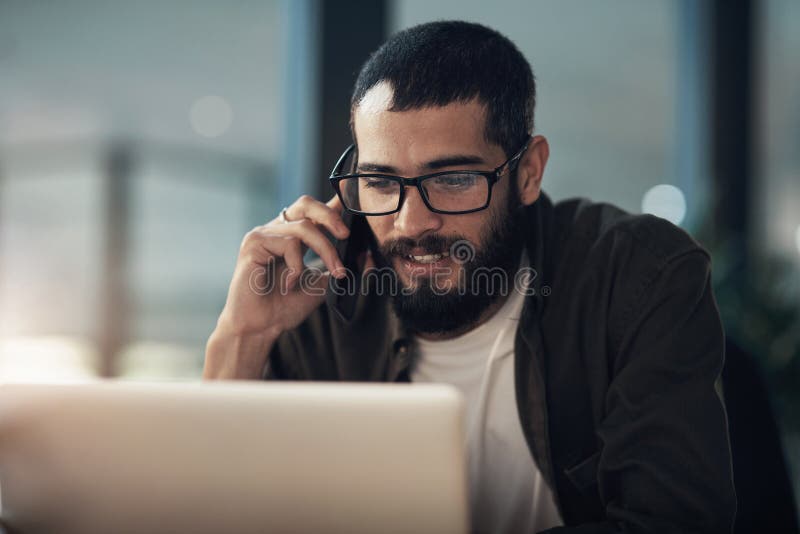 Creative man, night and laptop with phone call for web service, online advice or assistance at office. Businessman royalty free stock photo