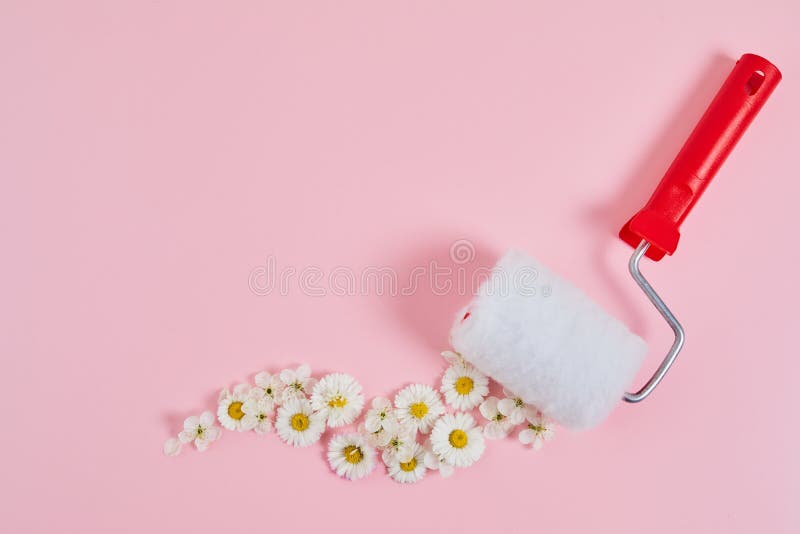 Creative Spring Blossom Concept. Paint Roller with Flower on a Blue