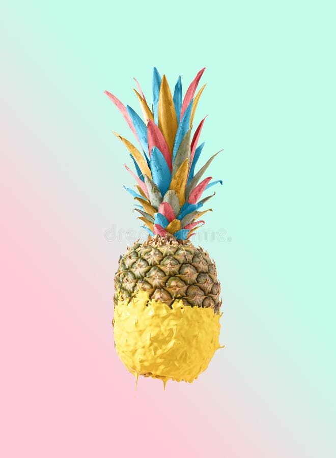 Creative Summer colorful pineapple fruit dripped in yellow paint. Tasty refreshing snack for beach party. Pastel pink and blue