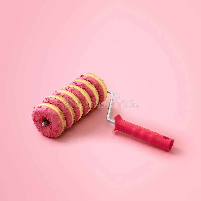 Creative Sweet Food Concept with Copy Space. Paint Roller with Donuts