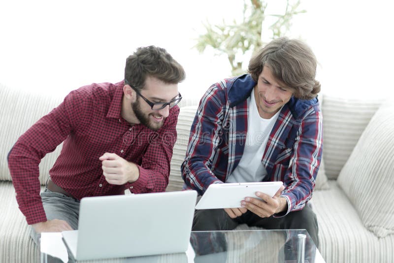 Creative web designers working with a tablet and a laptop. stock photography