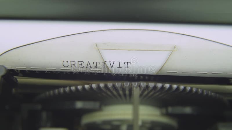 CREATIVITY Electric typewriter typing on white paper