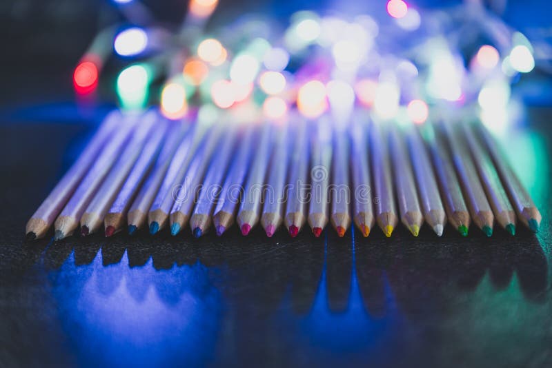 Assortment of Coloured Pencils on Dark Background with Psychedelic