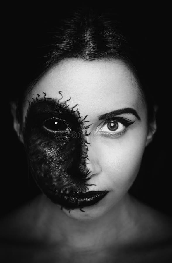 Creepy close-up portrait of a woman with a cursed mark on her face on dark background royalty free stock image Creepy close-up portrait of a woman with a cursed mark on her face on dark background royalty free stock image