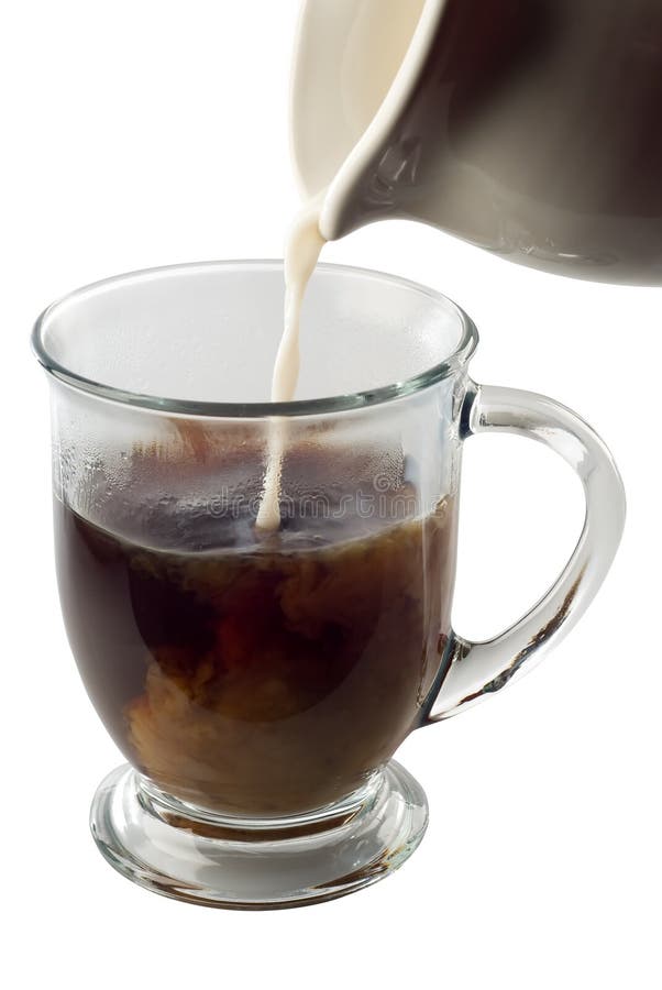 Cream pouring into coffee in a clear mug isolated on white with clipping path. Cream pouring into coffee in a clear mug isolated on white with clipping path