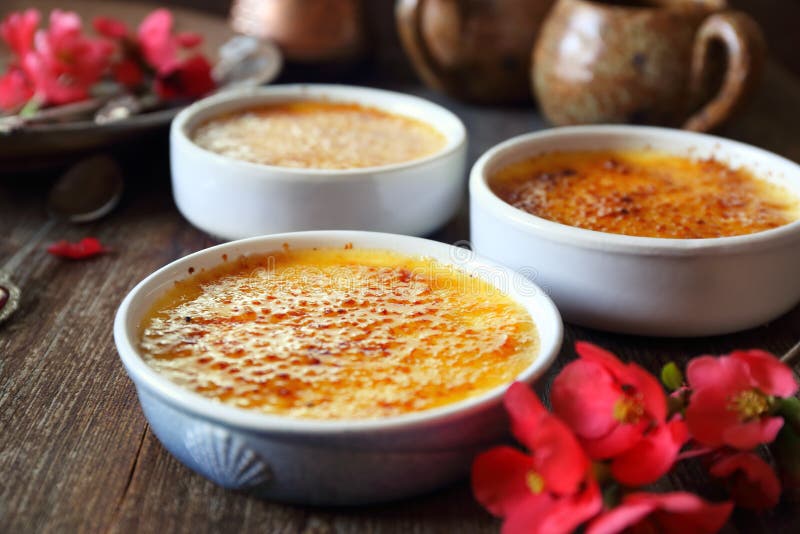Creme brulee, french traditional dessert, three portions. Rustic style. Creme brulee, french traditional dessert, three portions. Rustic style