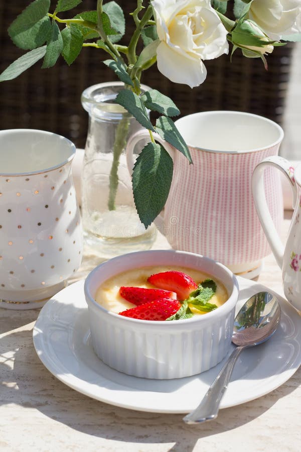 Creme brulee with fresh strawberry and green mint