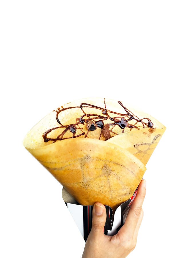Crepe with Chocolate Sauce for Breakfast or Dessert. Food Crepes Baked. Woman is Hand Holding Homemade Brown Pancake with Cereal royalty free stock image Crepe with Chocolate Sauce for Breakfast or Dessert. Food Crepes Baked. Woman is Hand Holding Homemade Brown Pancake with Cereal royalty free stock image