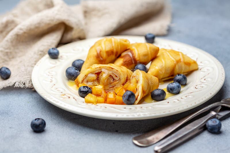 Crepes with apples, blueberries and caramel sauce stock photo Crepes with apples, blueberries and caramel sauce stock photo