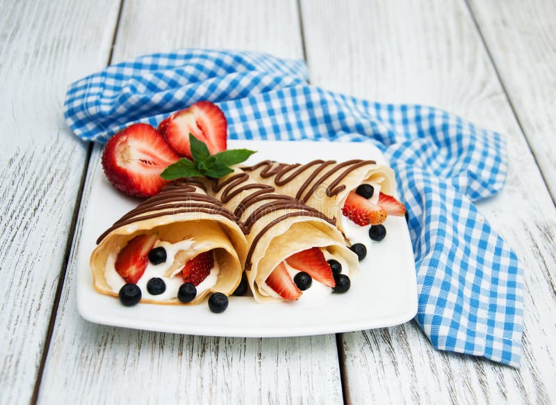 Crepes com morangos e molho de chocolate imagens de stock royalty free