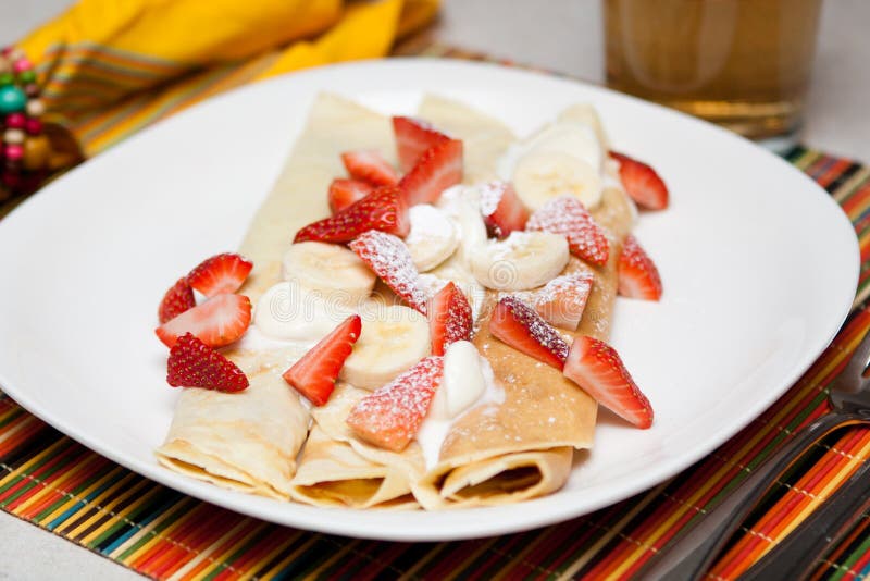 Crepes with strawberry, banana and whip cream stock images Crepes with strawberry, banana and whip cream stock images