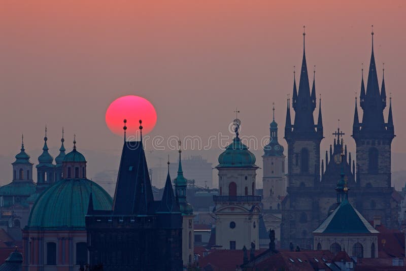 Twilight in historical city. Magical picture of tower with orange sun in Prague, Czech Republic, Europe. Beautiful detailed sunrise. Twilight in historical city. Magical picture of tower with orange sun in Prague, Czech Republic, Europe. Beautiful detailed sunrise.