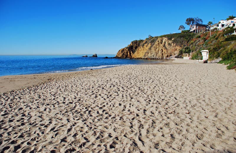 Image shows the, north end of Crescent Bay Beach in North Laguna Beach, California. This January morning photo was taken from the middle of the beach. The small rock formation in the ocean at the upper left is called Seal Rock. Image shows the, north end of Crescent Bay Beach in North Laguna Beach, California. This January morning photo was taken from the middle of the beach. The small rock formation in the ocean at the upper left is called Seal Rock.