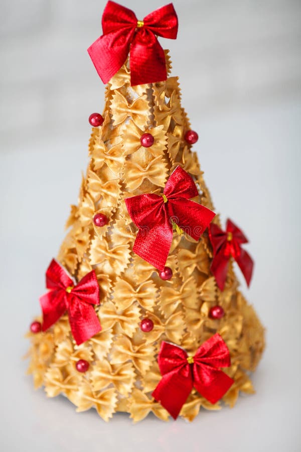Crianças é Artesanato. árvore De Natal Feita De Massas Pintadas De Ouro E Decoradas Com Arco Vermelho Foto de Stock - Imagem de colagem, xmas: 202831630 Crianças é Artesanato. árvore De Natal Feita De Massas Pintadas De Ouro E Decoradas Com Arco Vermelho Foto de Stock - Imagem de colagem, xmas: 202831630