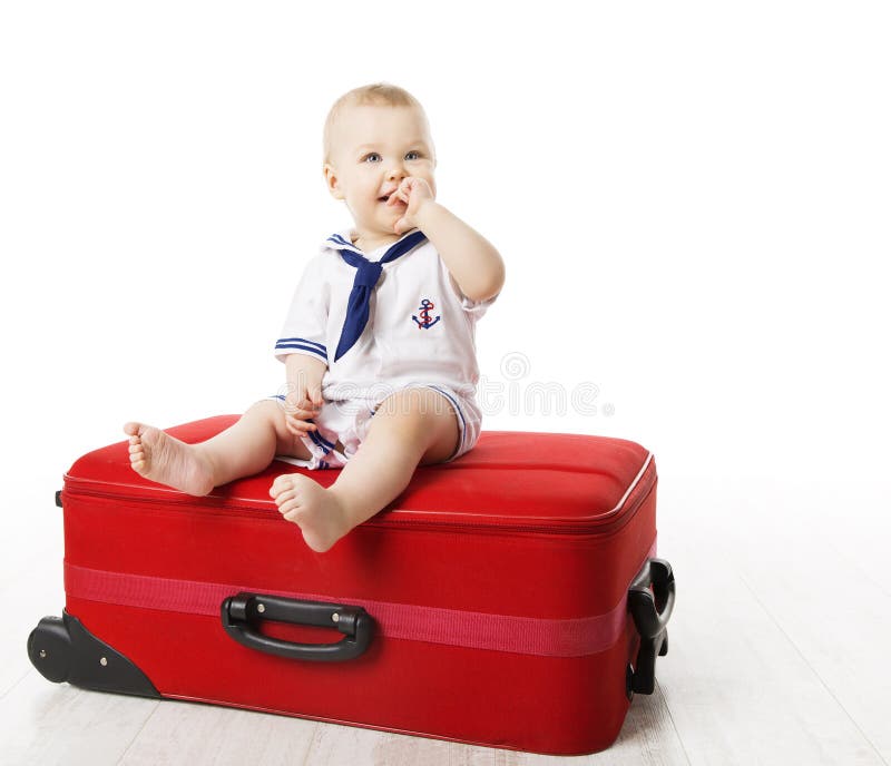 Kid on Travel Suitcase, Baby Boy Sitting on Red Luggage, One Year Old Child isolated over White background. Kid on Travel Suitcase, Baby Boy Sitting on Red Luggage, One Year Old Child isolated over White background