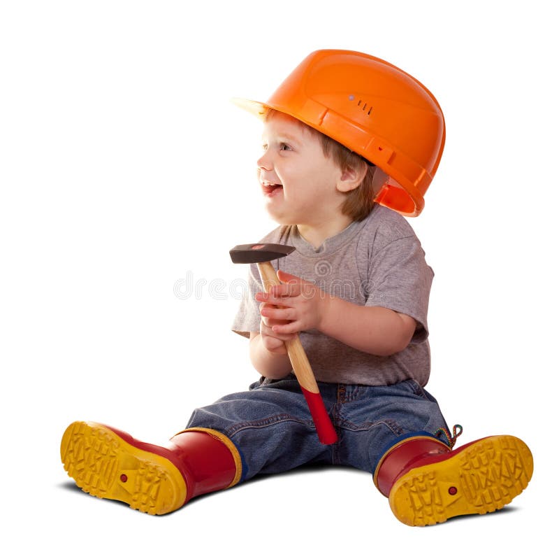 Criança no capacete de segurança com martelo imagem de stock royalty free Criança no capacete de segurança com martelo imagem de stock royalty free