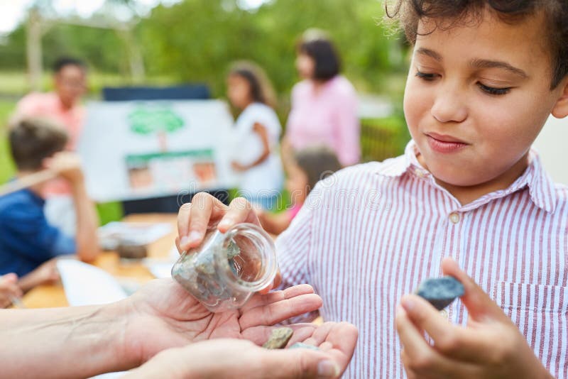 Child in the summer tuition course in natural history learns about rock and natural science. Child in the summer tuition course in natural history learns about rock and natural science