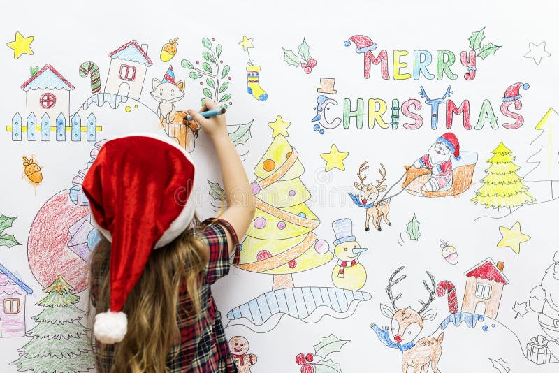 Criança que colore um desenho do Natal