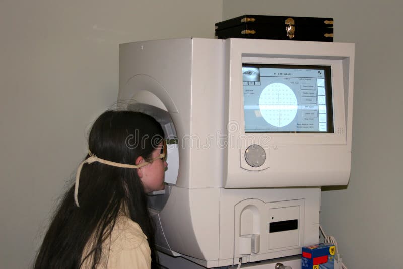 Young girl receiving the Field of Vision test for glaucoma. Shot with the Canon 20D. Young girl receiving the Field of Vision test for glaucoma. Shot with the Canon 20D.