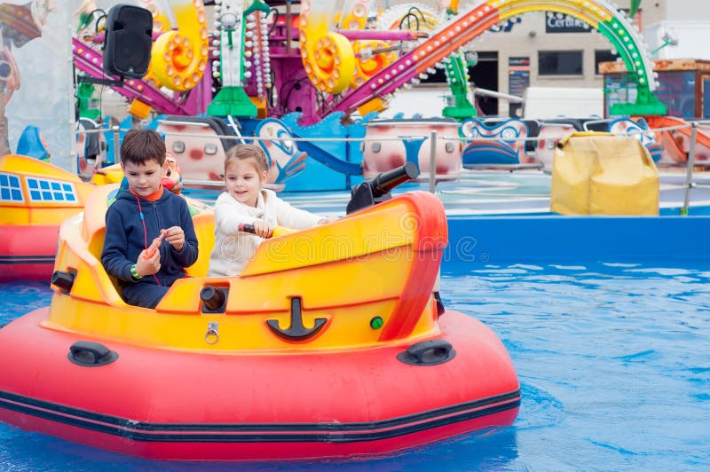 Crianças bonitas que têm o divertimento em um parque de diversões Crianças sobre fotos de stock Crianças bonitas que têm o divertimento em um parque de diversões Crianças sobre fotos de stock