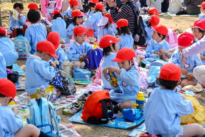 Osaka , JAPAN - OCTOBER 29, 2009: Japanese pre-school kids are unpacking their lunch boxes during an excursion trip in Osaka. Japanese school systems are well known for discipline education. Osaka , JAPAN - OCTOBER 29, 2009: Japanese pre-school kids are unpacking their lunch boxes during an excursion trip in Osaka. Japanese school systems are well known for discipline education.