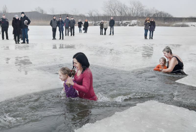 Crianças, meninas com os adultos que nadam no rio no esmagamento cristão do feriado do inverno foto de stock Crianças, meninas com os adultos que nadam no rio no esmagamento cristão do feriado do inverno foto de stock