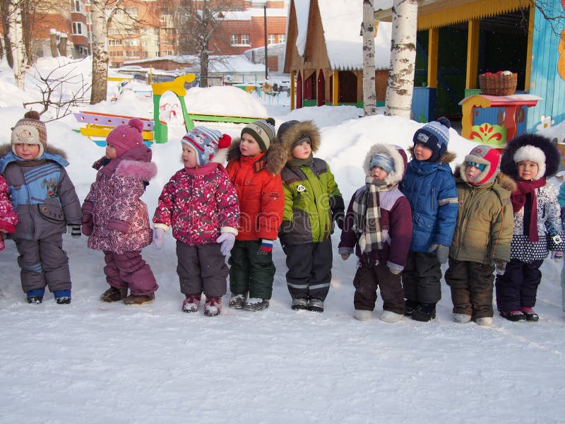 Group of preschool children walking in kindergarten in winter, Russia. Group of preschool children walking in kindergarten in winter, Russia