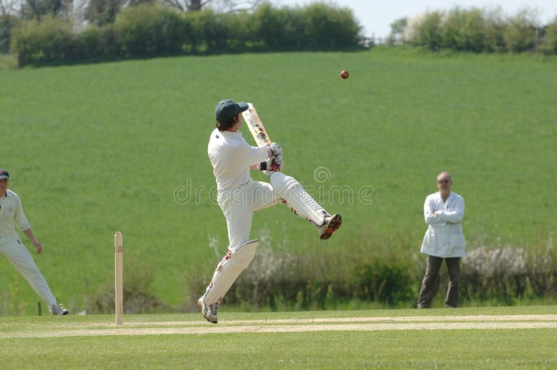A Cricket batsman hitting the ball