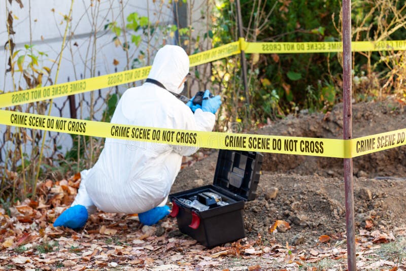 Crime scene investigation. Forensic science specialist working on human remains identification. Crime scene investigation. Forensic science specialist working on human remains identification